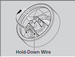 3. Remove the hold-down wire, then remove