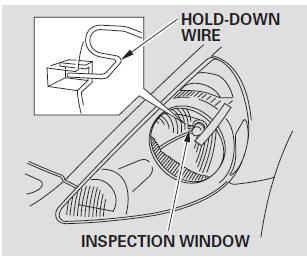 7. Make sure that the hold-down wire is installed properly and securely. You