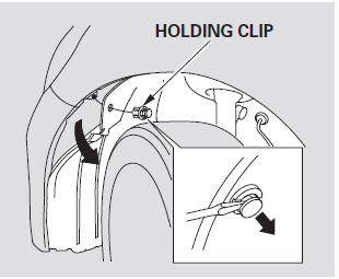 2. Use a flat-tip screwdriver to remove the holding clip from the inner fender,