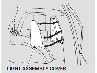 1. Open the tailgate. Place a cloth on the edge of the light assembly cover.